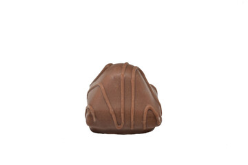 A chocolate candy with filling lies on the table.