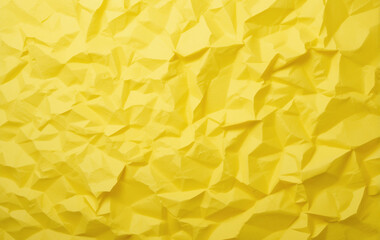 Bright yellow crumpled paper with a textured surface, creating a vibrant, abstract pattern.