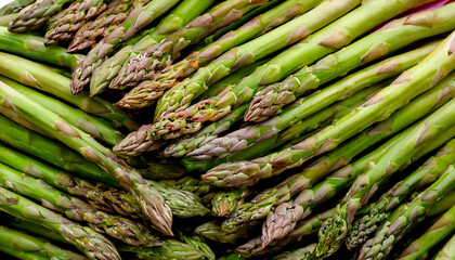 Detailed view of fresh asparagus spears, highlighting their tender tips and vibrant green color. Perfect for healthy food, salads, or vegetable concepts. Texture, background.