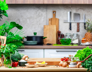 Healthy eating, cooking, food blogging background. Oak cutting board with vegetables, herbs, mushrooms and linen towel on cozy kitchen with wooden table, kitchenware and ingredients