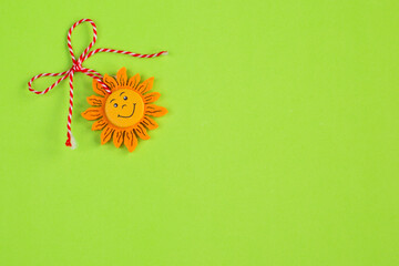 Bulgarian Martenitsa and sun on green background