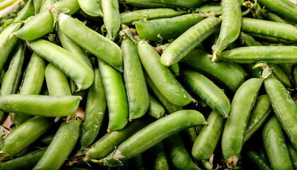 Fototapeta premium Detailed view of fresh pea pods, emphasizing their smooth texture and bright green color. Perfect for healthy food, salads, or vegetable concepts. Texture, background.