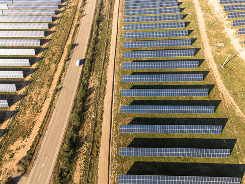 Aerial view of a solar farm in Teruel, Spain, with rows of photovoltaic panels generating renewable energy. Sustainable infrastructure for green power.