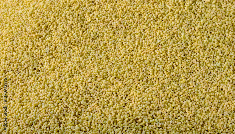 Fototapete repeating pattern of tiny couscous grains, emphasizing their uniform size and golden color. ideal fo