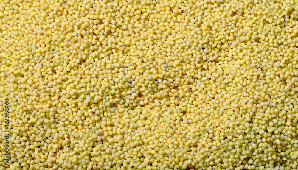 Fototapete repeating pattern of tiny couscous grains, emphasizing their uniform size and golden color. ideal fo