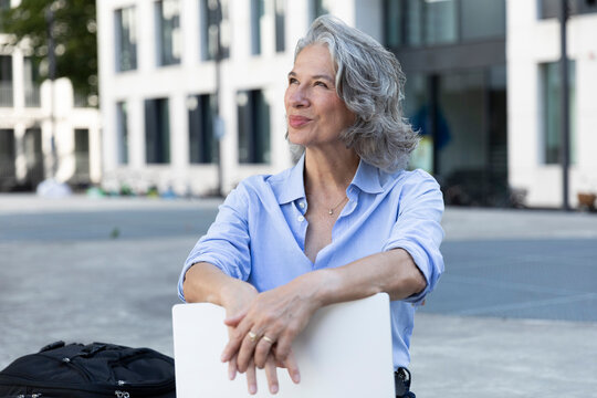 Businesswoman enjoying remote work in an urban setting