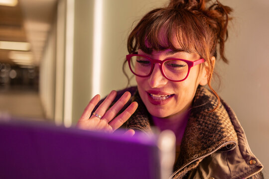 Woman wearing eyeglasses talking on video call through tablet PC