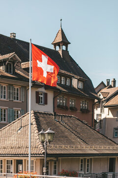 Traditional architecture in Laufenburg, Aargau, Switzerland with Swiss flag