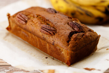 Banana bread loaf on wooden table.