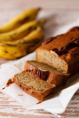 Banana bread loaf on wooden table.