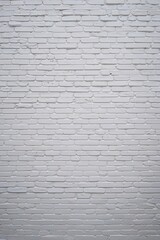 Fototapeta premium style and type of a white brick wall, showcasing a classic and rustic layout. The bricks are arranged in a horizontal pattern, with each row slightly offset from the one above, creating a traditional 