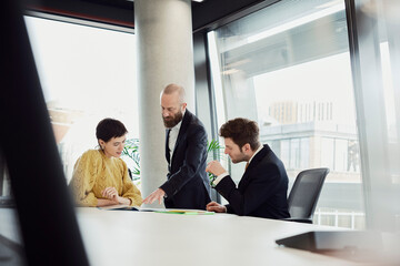 Colleagues in a modern boardroom discussing business strategy