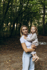Fototapeta premium Mother and Daughter Embracing In a Tranquil Forest Setting