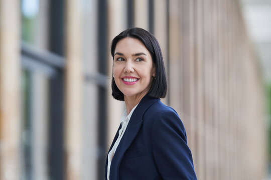 Businesswoman at a trade fair looking confident and smiling