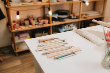 Set of craft sculpting tools on table in pottery workshop. Pottery gears for molding ceramics.