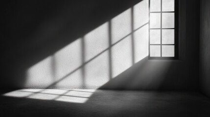 Sunlight streams through window in empty room, casting shadows on wall