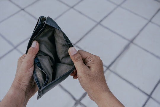 Man hand holding empty wallet. No money.