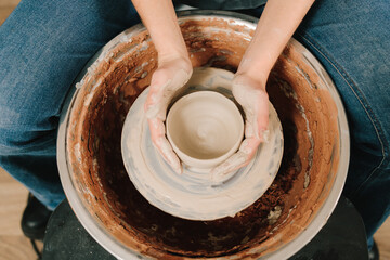 Potter creates a ceramic bowl in the pottery studio. Process of making a unique ceramic shape.