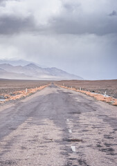 Asphalt road of the Pamir Highway in the valley of the Tien Shan Mountains in Tajikistan in the...