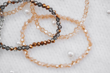 Elegant beaded bracelets displayed on soft fabric with pearl accents