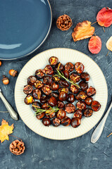 Warm roasted chestnuts served on a plate
