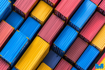 Colorful shipping containers stacked high, aerial view.  Global trade, logistics background