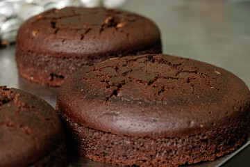 Deliciously baked chocolate cakes cooling on a counter in a cozy kitchen setting, perfect for any celebration or dessert lover to enjoy