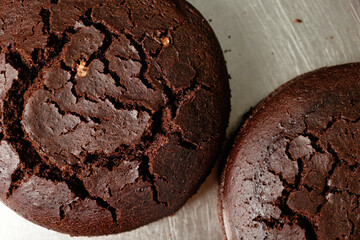 Decadent chocolate cakes cooling on a metal surface, revealing rich texture and inviting aroma perfect for any celebration or gathering