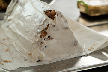 Delightful dessert adorned with creamy frosting and layers of flaky pastry in a vibrant bakery setting