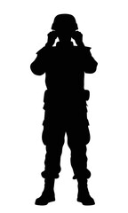 Silhouette of a soldier standing with binoculars