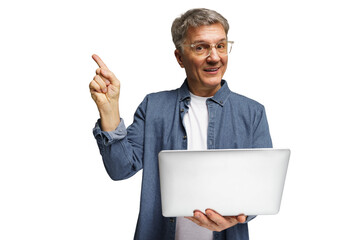 Older man holding laptop with a cheerful expression, pointing upward with one finger in a bright...