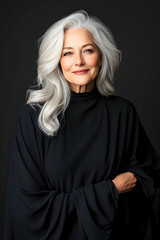 Fototapeta premium Mature woman portrait with grey hair, against black backdrop, beauty, fashion