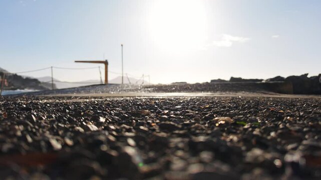 A rocky road at sunrise with a view of the coastal landscape in Bogliasco, Liguria