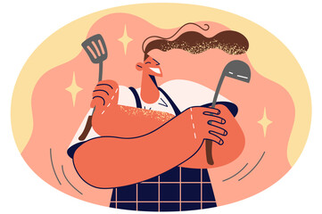 Smiling woman in apron holding kitchen utensils