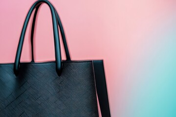 Close-up of a luxury black shopping bag on a pastel backdrop