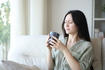 Asian woman complaining about coffee bad taste
