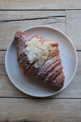 Almond Croissant Bakery homemade on Table. Traditional French breakfast gold crispy croissant. Fresh almond croissant