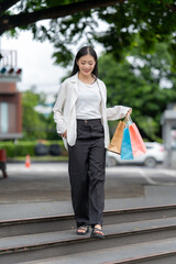 Retail Therapy's Embrace: A stylish figure descends steps after a successful shopping experience,...