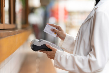 Contactless Payment with Card: A modern individual is depicted in a close-up, using a credit card...