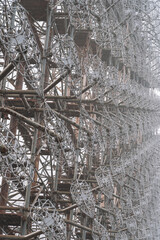 Radar arc in Chernobyl. Old collapsing radar antenna on sky background