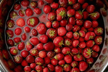 strawberries washed in the water in big bowl
