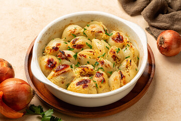 Oven baked Stuffed Onion. Filled with rice and meat. Traditional Greek or Turkish dishes, Salantourmasi or Sogan dolmasi. Top view, vertical image.