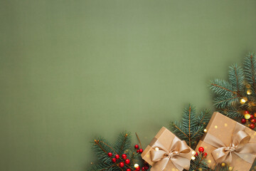New Year card with Christmas gift boxes with fir brunches on khaki background.