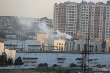 Fototapeta premium Baku, Azerbaijan. Buildings look faded due to smog and air pollution over the city. The air in the city center is polluted by restaurants, factories and cars