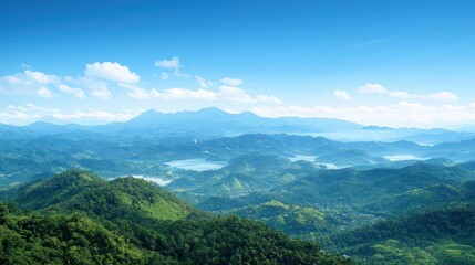 Obraz premium Expansive Green Hills and Distant Mountains under a Blue Sky