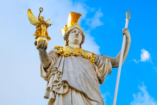 Pallas Athena statue in front of Austrian Parliament, Vienna, Austria against the blue cloudy sky background
