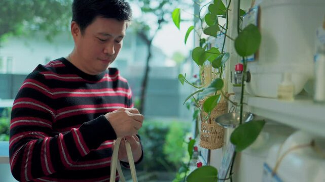 Customer fills cereal foods in a glass jar, lever the reusable container on refill store shelves, zero-waste and plastic-free grocery, environment-friendly, sustainable lifestyles.	
