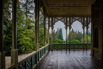 Historic veranda of the Chavchavadze estate in Tsinandali, Kakheti, Georgia, surrounded by lush greenery and classic Georgian architecture.