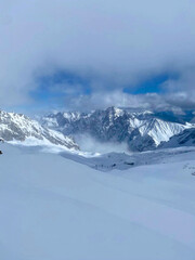 Majestic Snow-Covered Mountain Peaks Under a Cloudy Sky