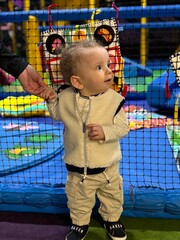 A baby boy playing and having fun in a soft play centre